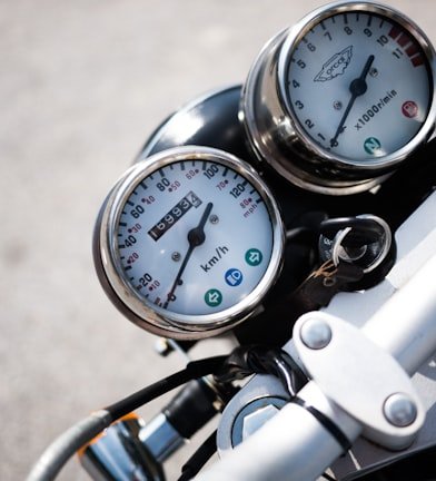 Selective focus photography of motorcycle speedometer